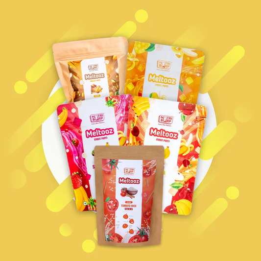 A spread of healthy Indian snacks for kids, including fruit puffs and baked millet snacks